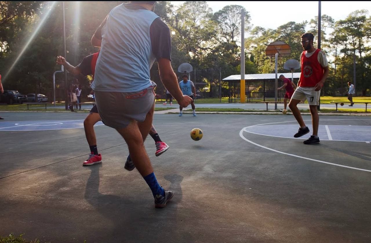 Players in motion at sunset on the futsal court