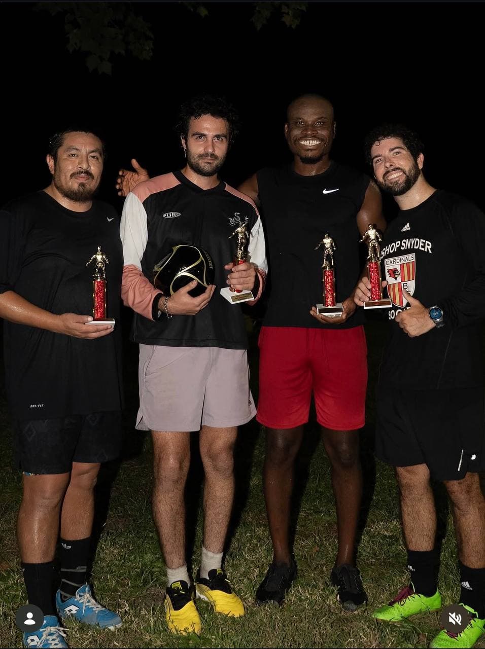 Champions holding trophies after a match
